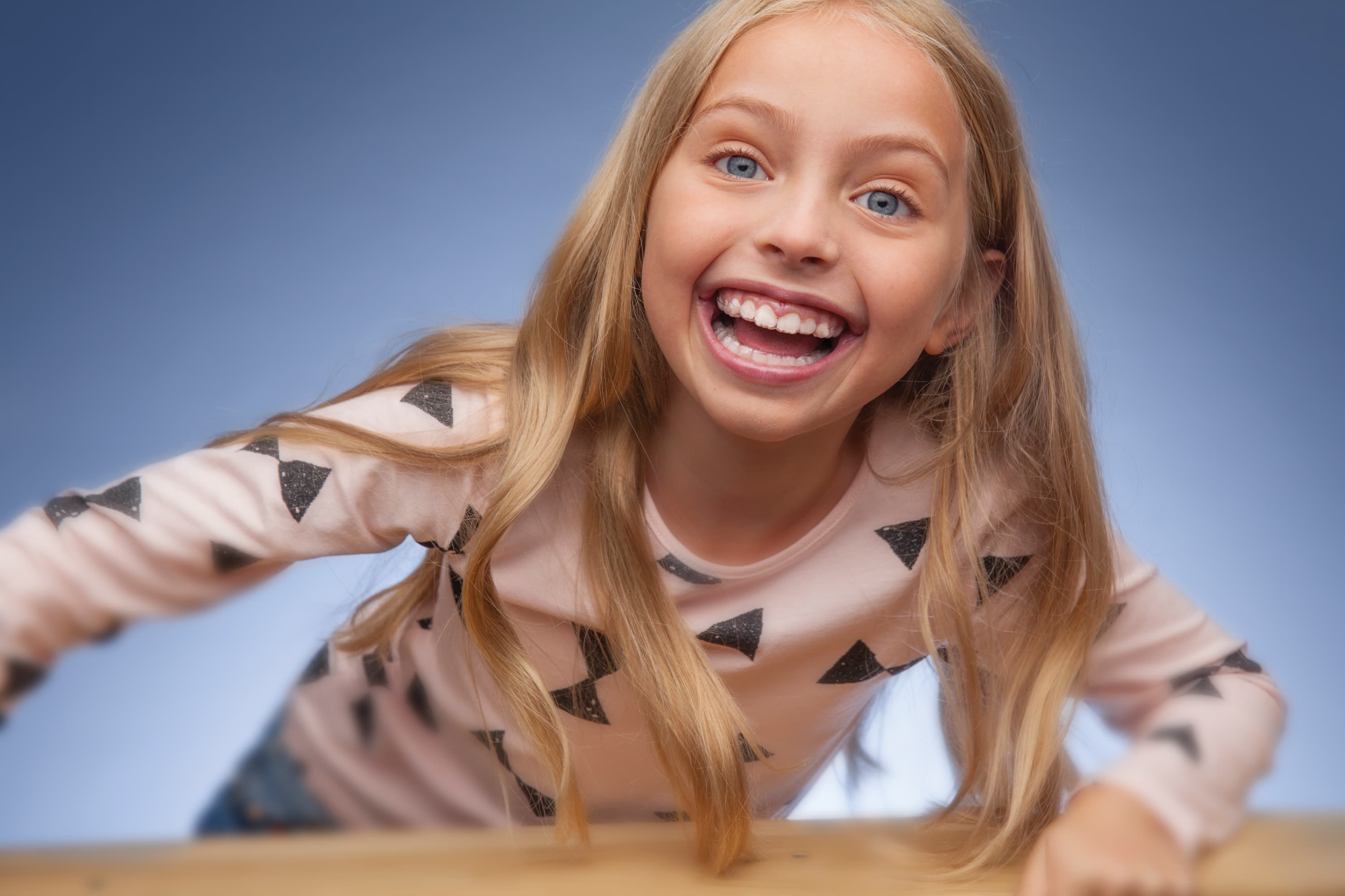 girl smiles with clear aligners