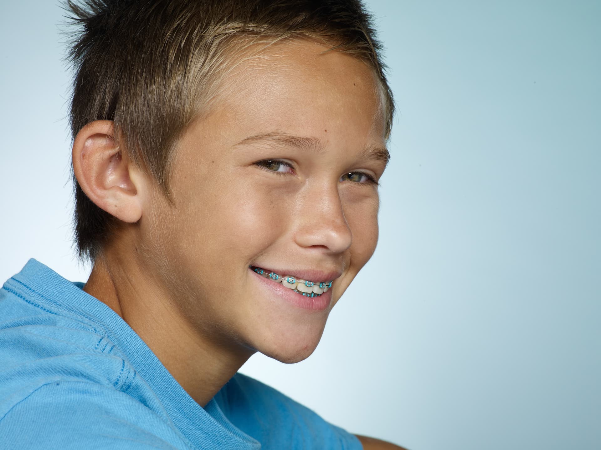 boy smiles with braces