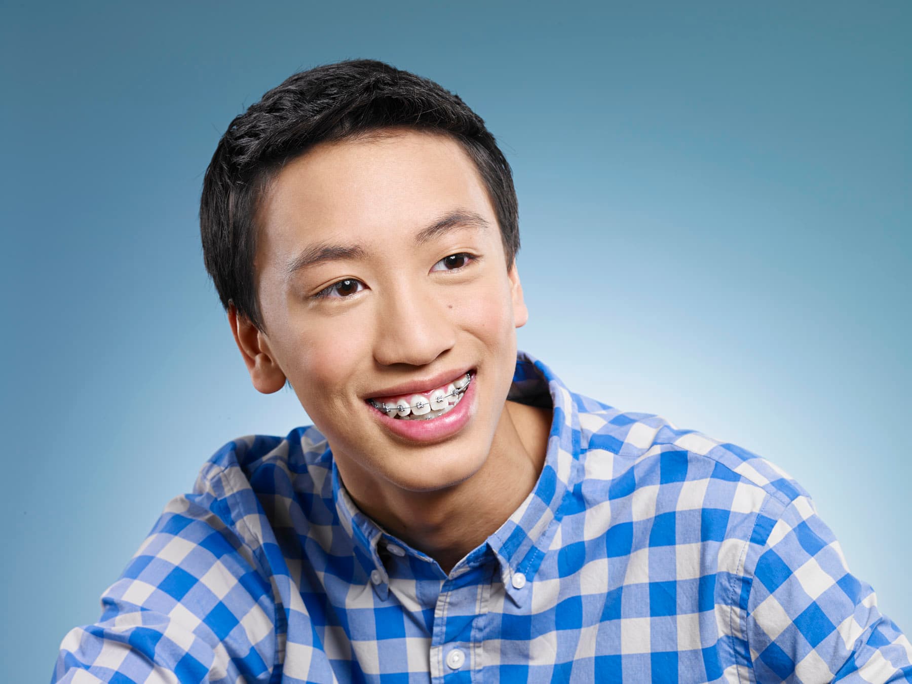 boy smiles with braces