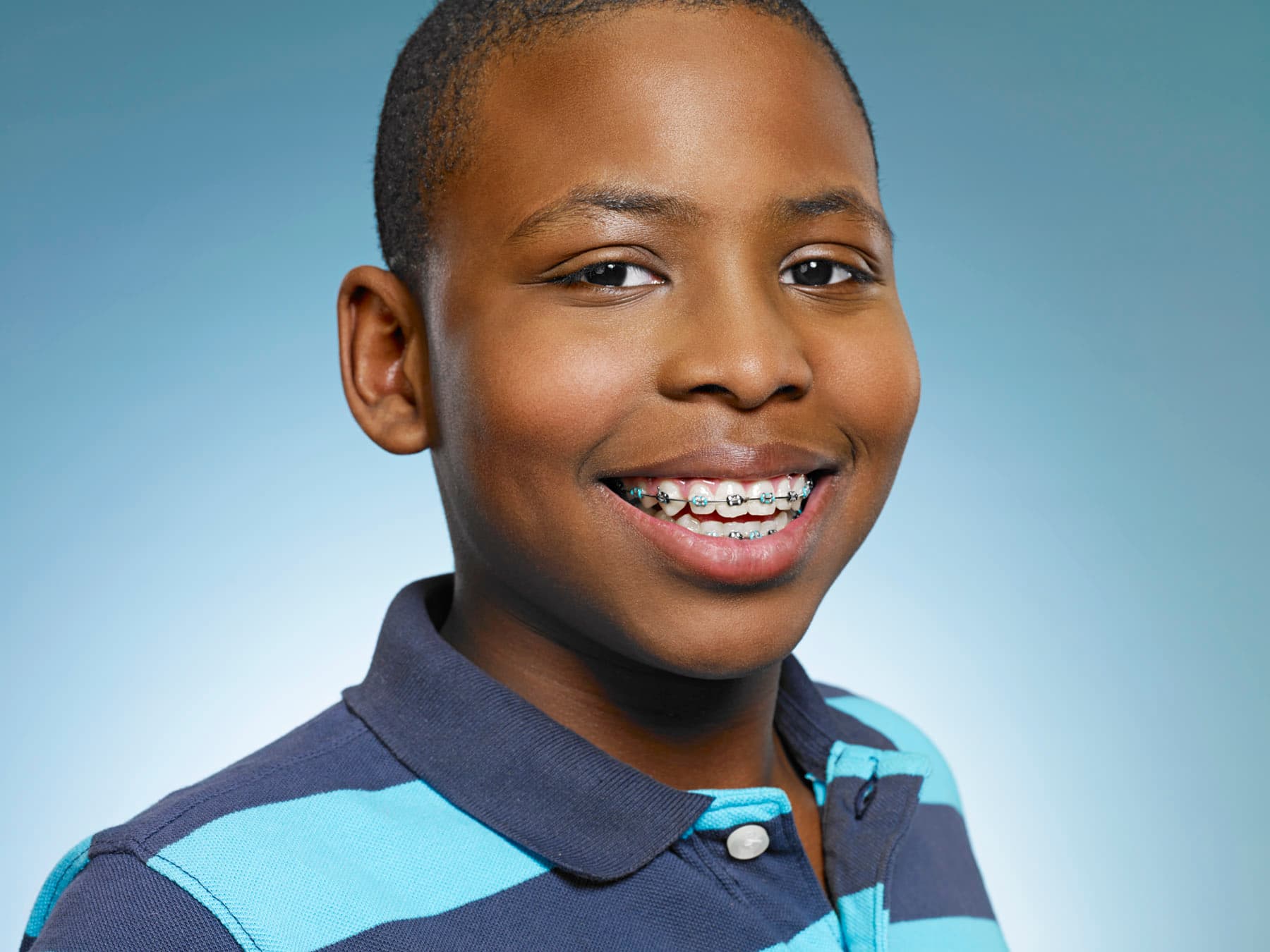 boy smiles with braces