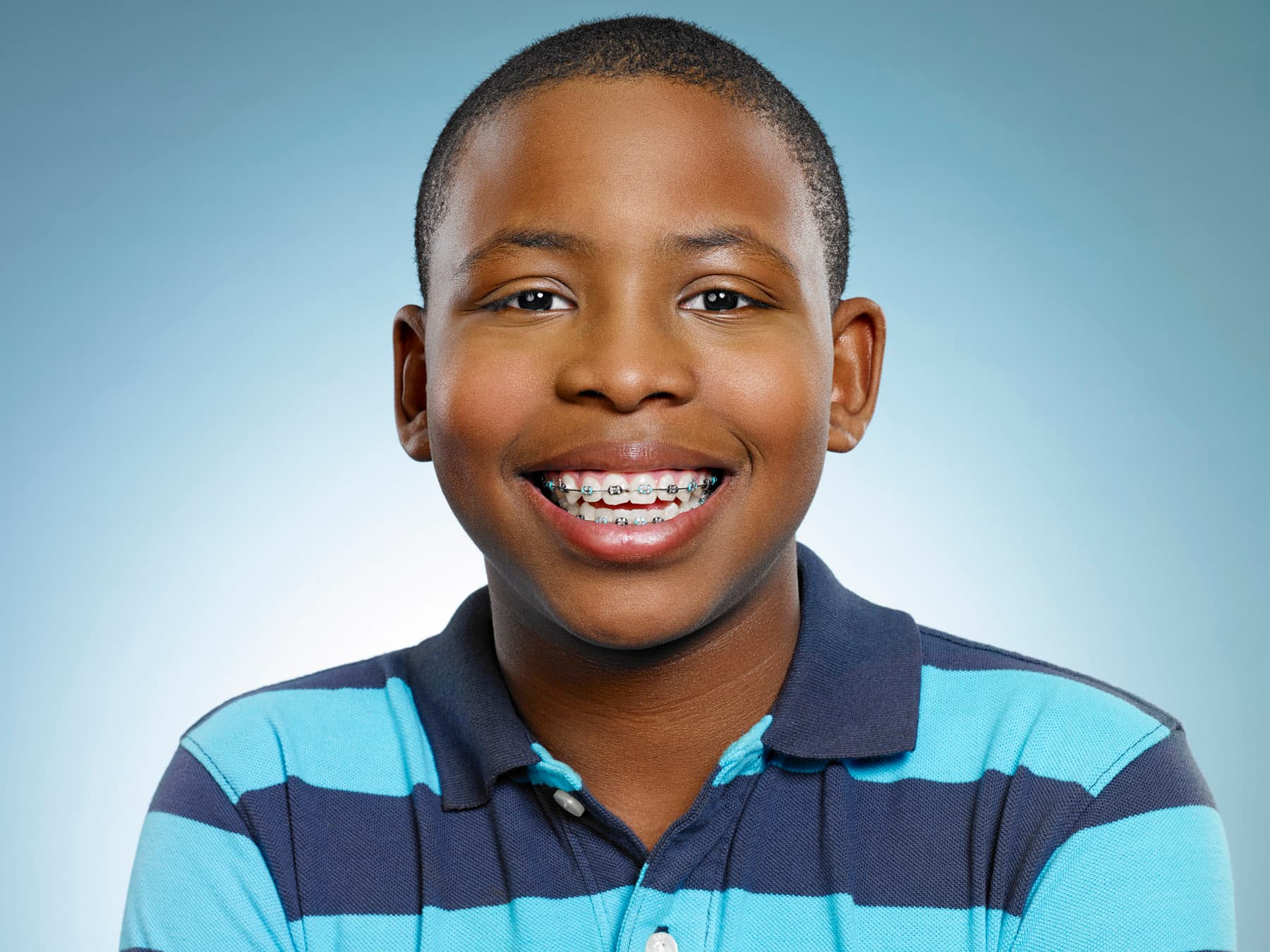 Teen patient smiling after orthodontic treatment